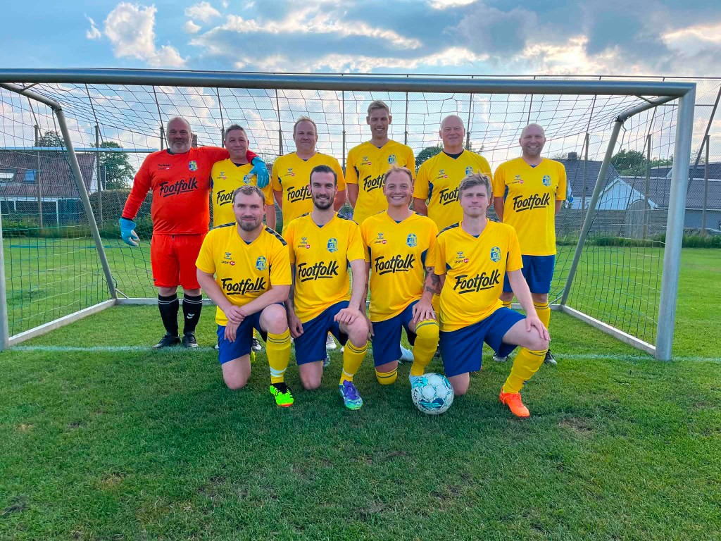 A local sports team lined up in yellow Footfolk shirts