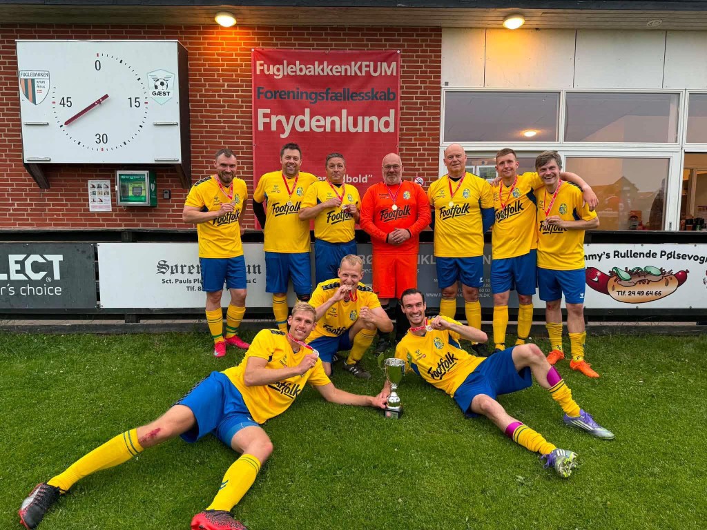 A local sports team in yellow Footfolk shirts with a trophy